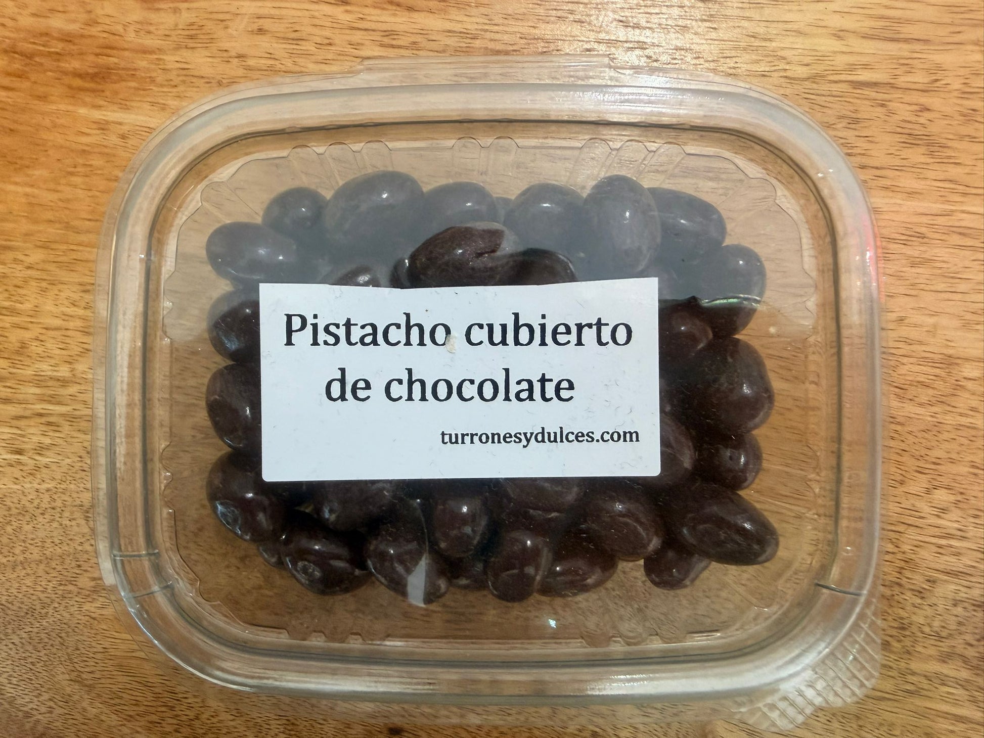 pistacho cubierto de chocolate negro por 150 g